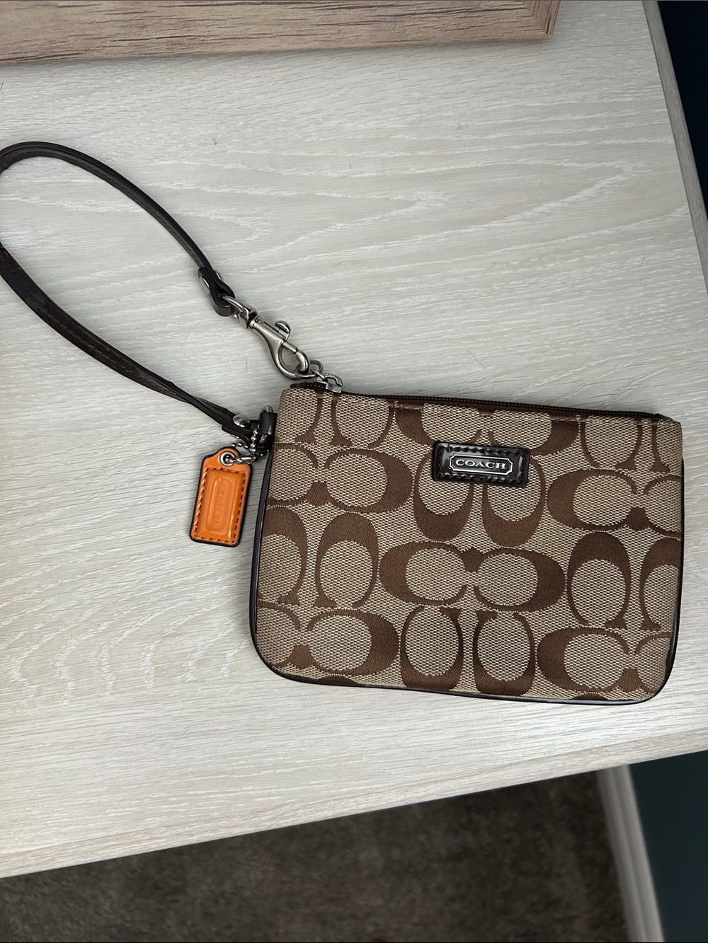 Coach Brown Signature Canvas Wristlet with Orange Charm